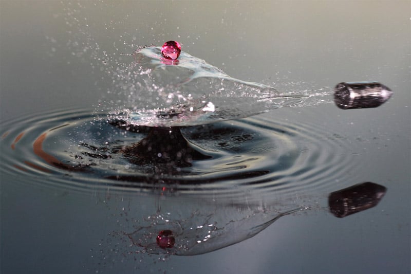 A freeze-frame of a bullet shot through water