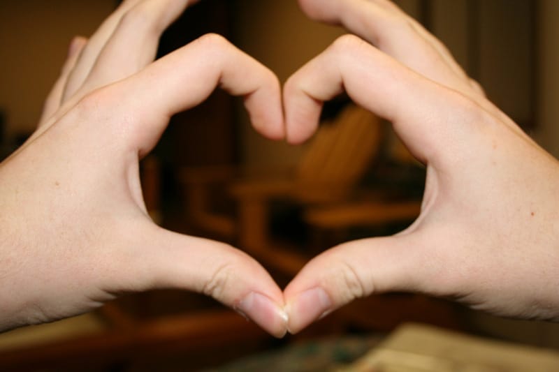 Forming the heart shape with fingers
