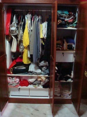 My wardrobe with neatly folded clothes