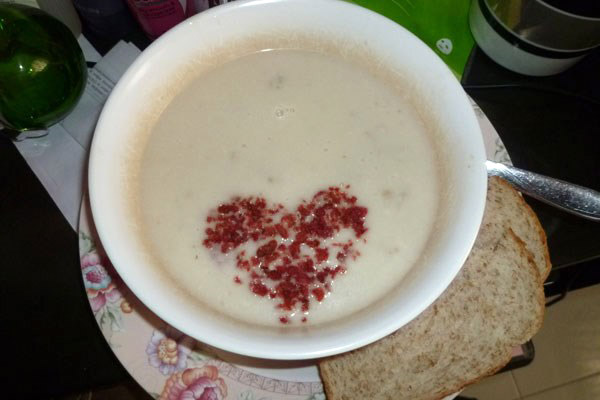 Heart shape in soup, made of bacon bits